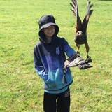 Young boy holding a bird of prey