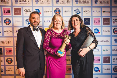 Mentoring Plus representatives holding a trophy at the Bath Life Awards 2022