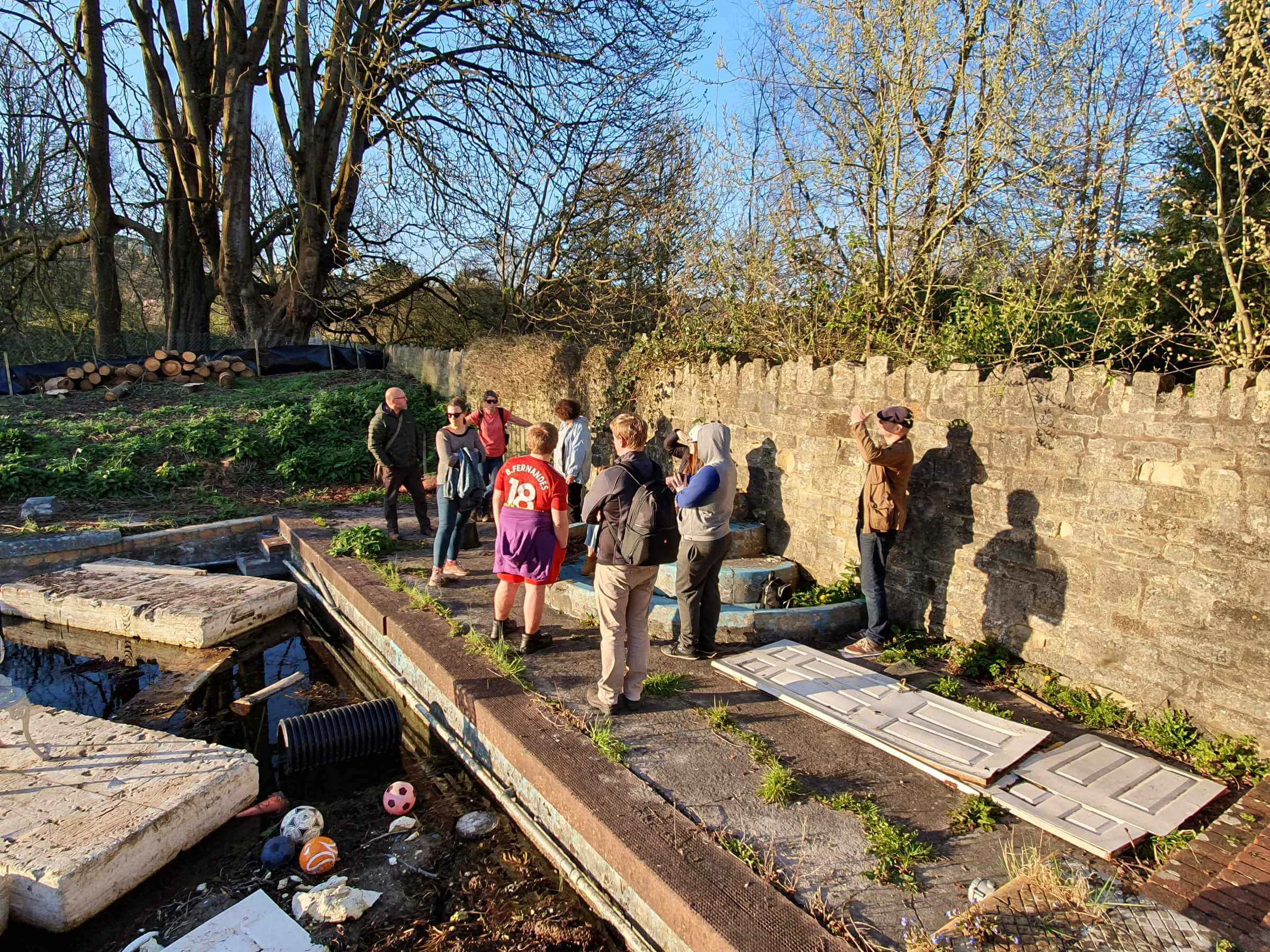 Mentoring Plus youth reps and staff visiting Cleveland Pools in Bath, gathered beside the empty pool