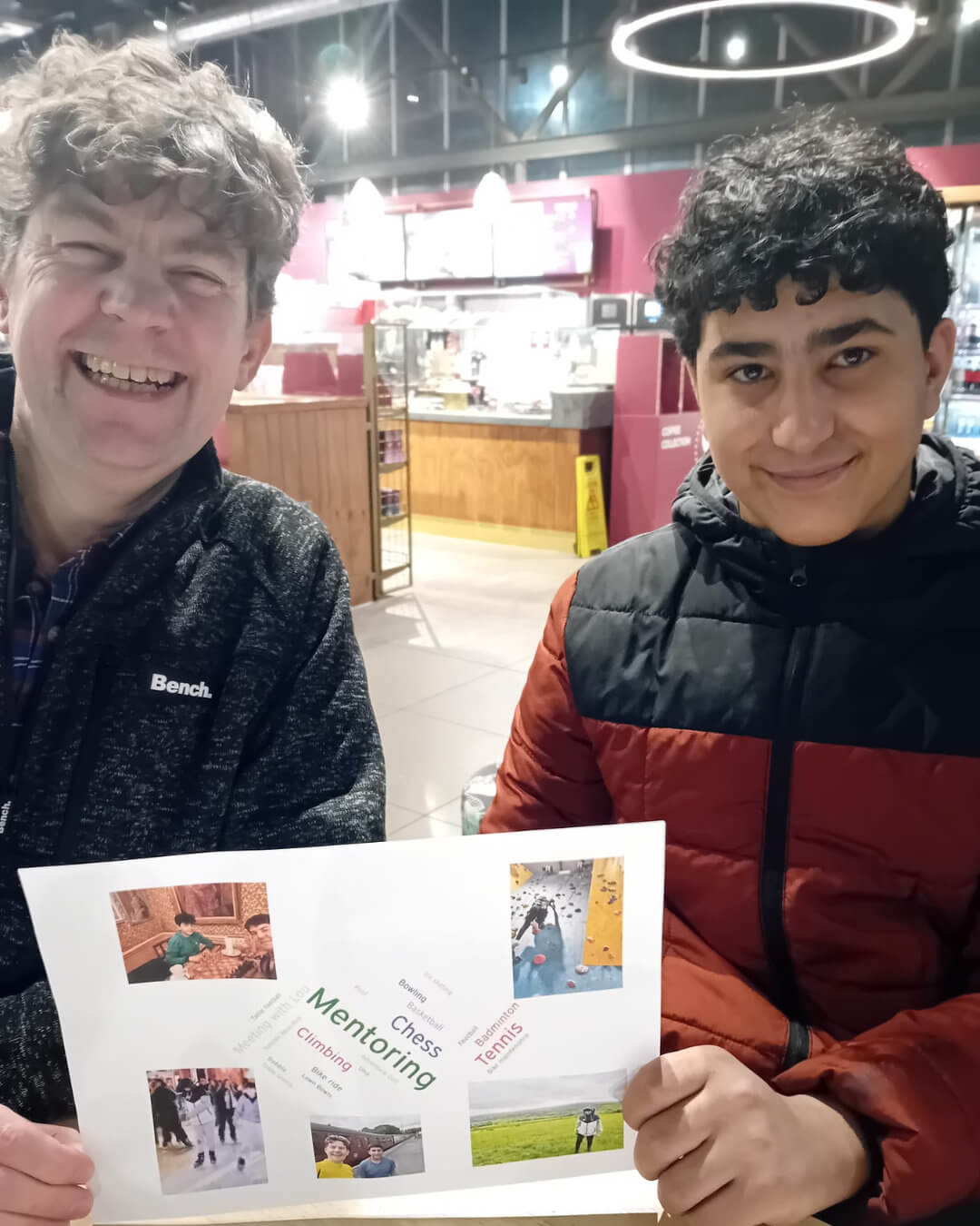 A mentor and mentee holding up a collage of photos and words summarising their activities together
