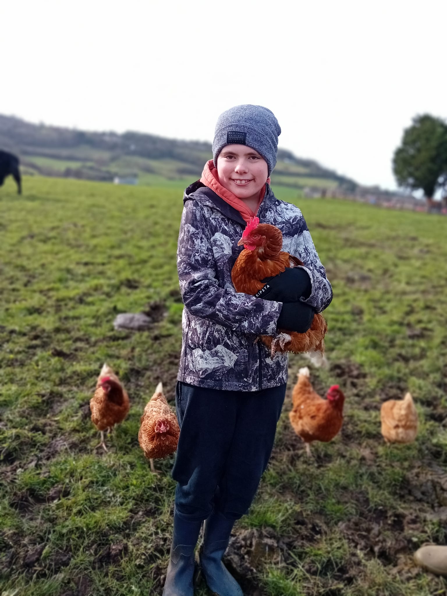 Mentee at Jamie's Farm holding a chicken