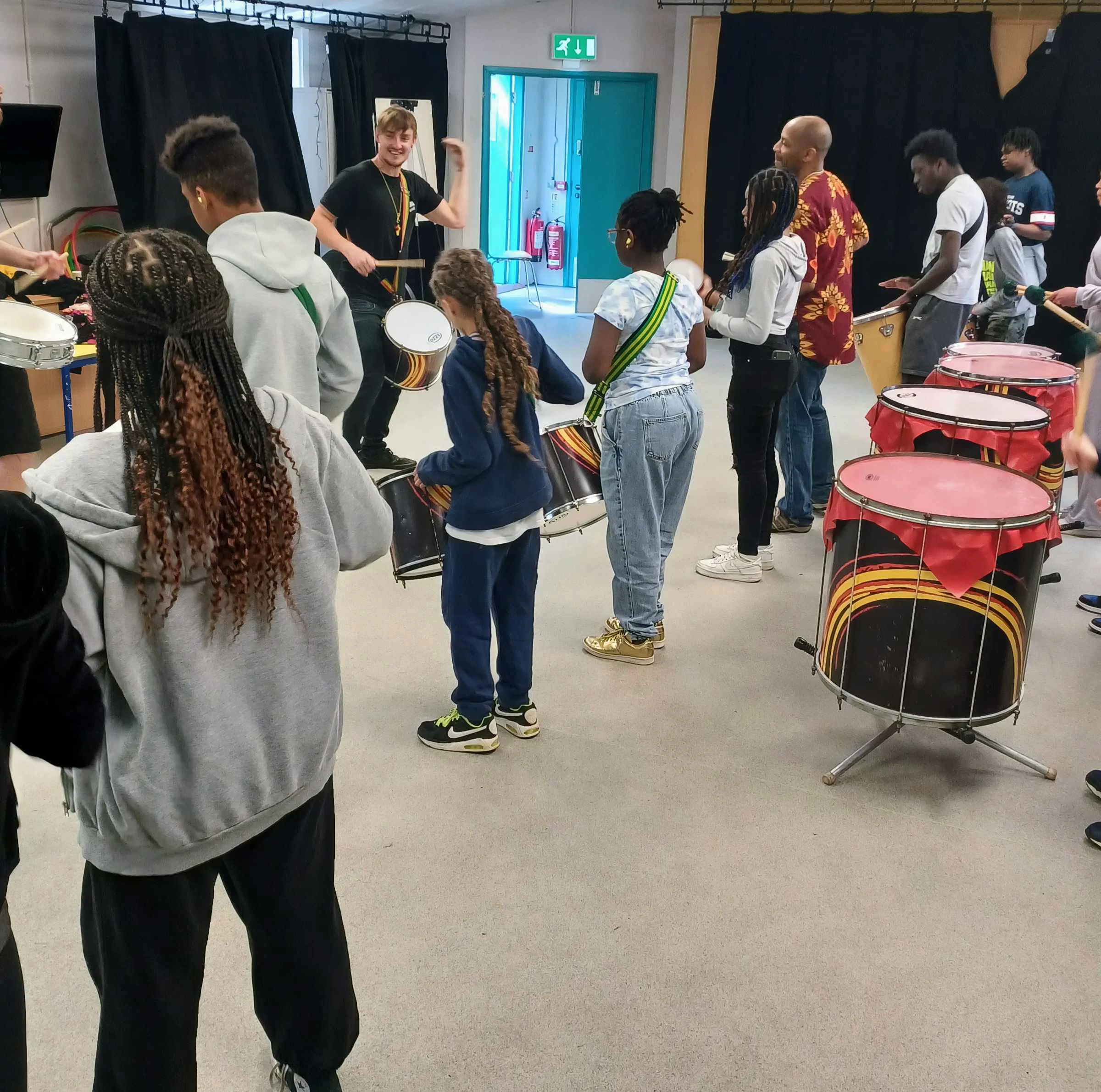 Young people being taught how to play drums at Riverside Youth Hub