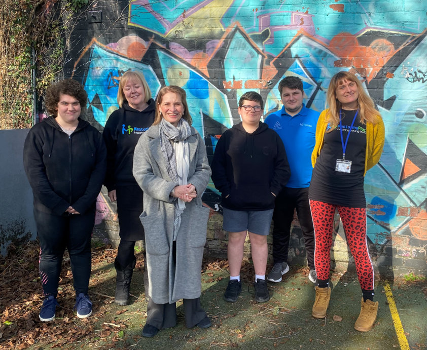 Mentoring Plus team in the ball court at Riverside Youth Hub celebrating 25 years