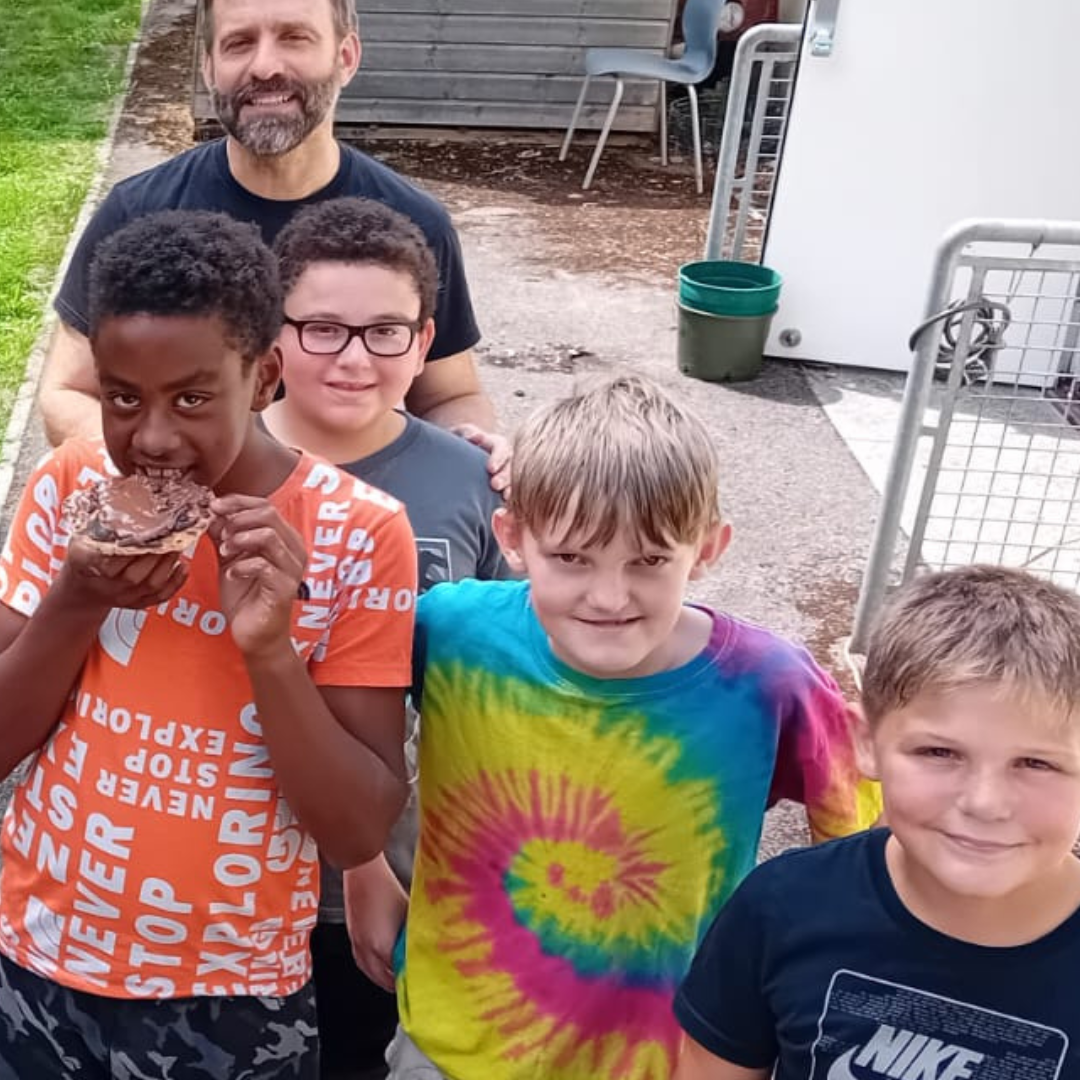 Photo of a group of primary aged boys with one of our practitioners